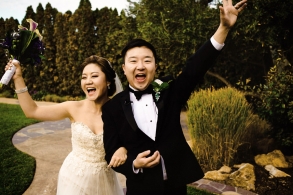 A newly happily celebrates as they walk off their Wedding Ceremony